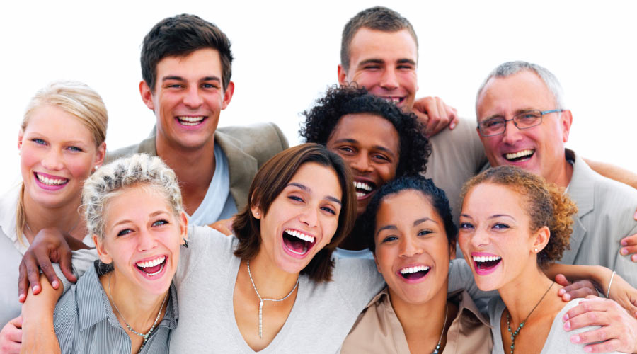 A group of 9 smiling friends of various ages, genders and ethnicities